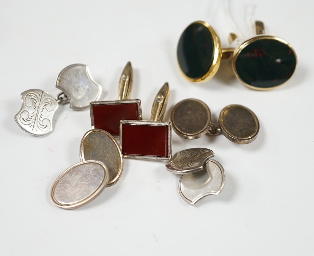 A modern pair of 9ct gold and bloodstone set oval cufflinks, 23mm, gross weight 12.6 grams, together with three other pairs of cufflinks including silver and 'gold on silver'. Condition - fair to good